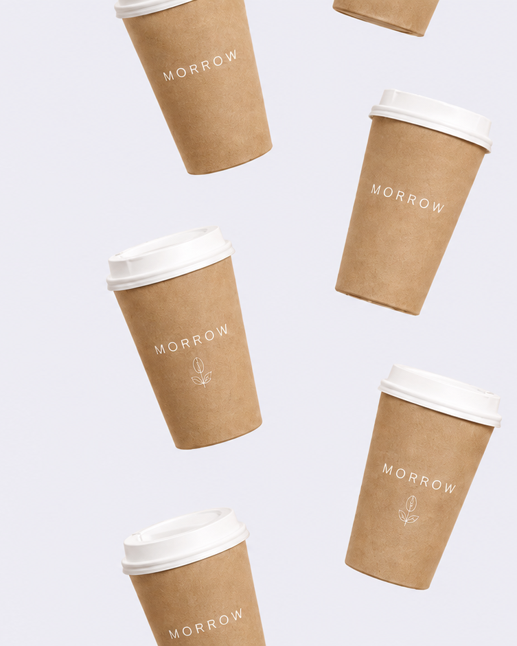 Kraft paper coffee cups with white lids on a light gray background